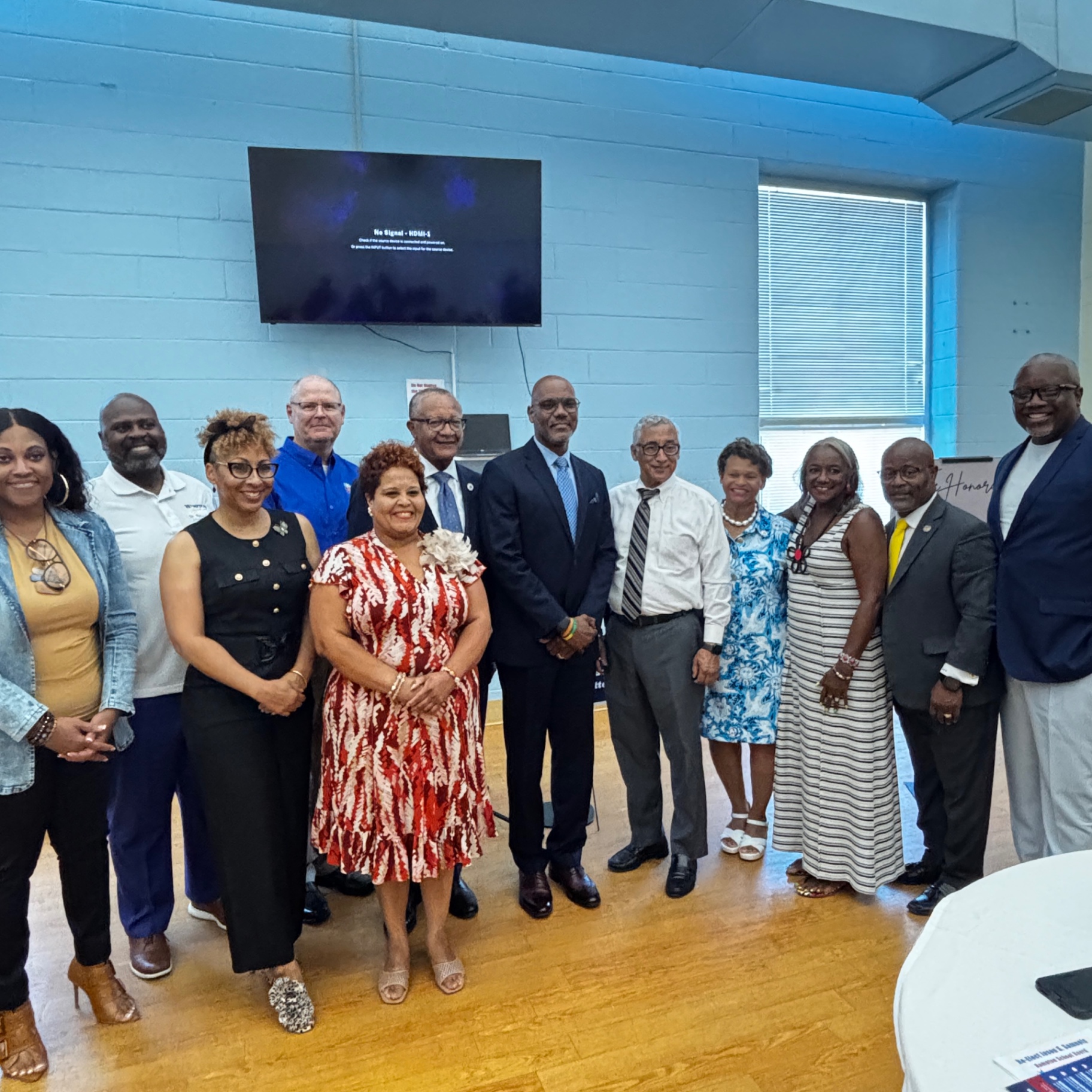 Group portrait of supporters and volunteers gathered at the August 23 kickoff school supply drive.